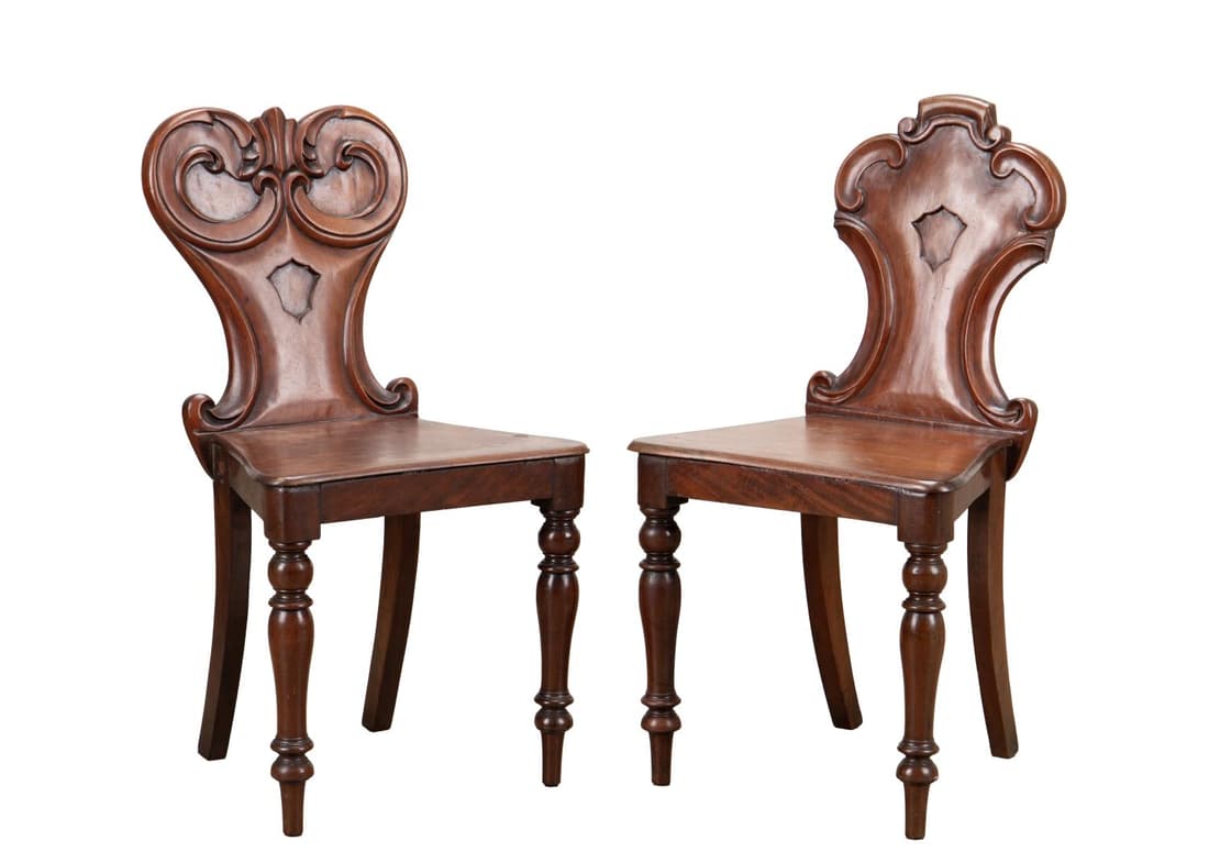 PAIR 19TH C. WILLIAM IV MAHOGANY HALL CHAIRS: Pair of William IV/Victorian mahogany hall chairs, 19th century, with a cartouche form back and rising on front turned legs, having no apparent marks. Approximate measurements: h. 31. 5", w. 16. 75", 
