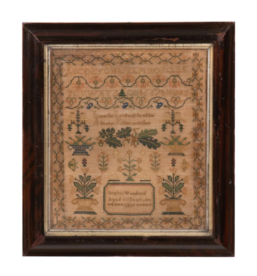NEEDLEWORK SAMPLER, SOFIA WOODARD, 1839: Needlework sampler, having bands of alphabet and numbers divided by meandering vines, above a quote â€œO Love the Lord and he will be a tender Father unto thee” surmounting oak leaves, baske