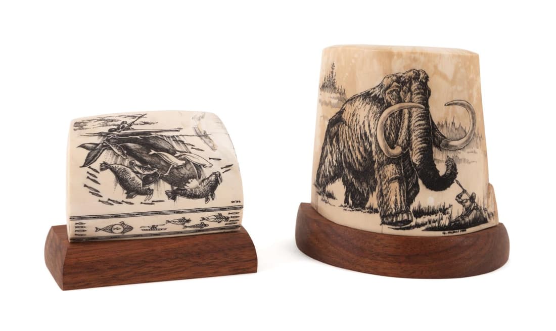 TWO G. OLSEN SIGNED FOSSIL MAMMOTH SCRIMSHAWS: Two pieces of signed Geoff Olsen (American/Alaska b. 1956), fossilized mammoth tooth scrimshaw, the first depicting a stone age hunter confronting a woolly mammoth, signed at lower right and dated 199