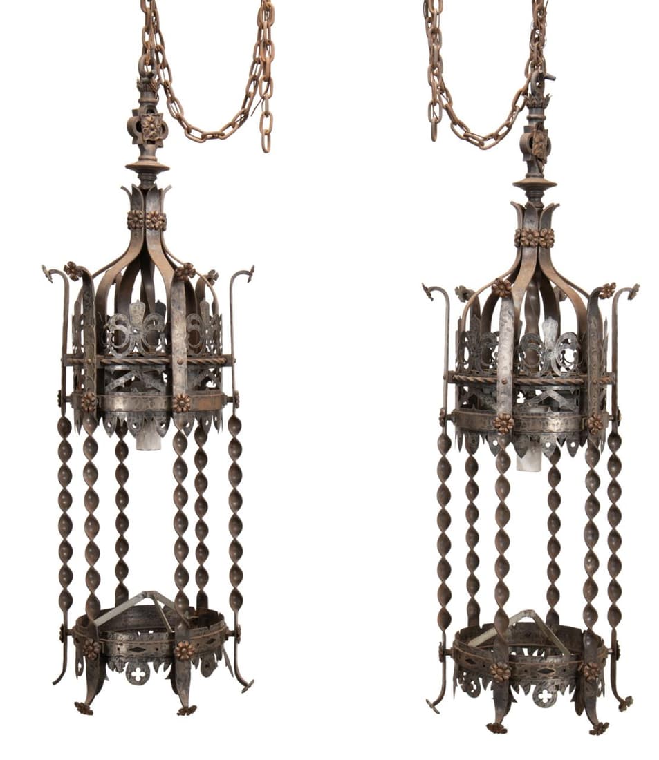 PR GOTHIC REVIVAL IRON LANTERN CHANDELIERS: Pair of French Gothic Revival wrought iron five light hanging lantern chandeliers, early 20th century, each having a pierced body, foliate and fleur de lis motif, and spiral supports, apparently unmar