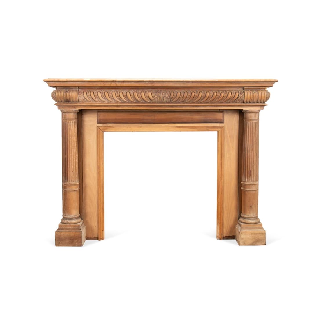 AMERICAN VICTORIAN CARVED WOOD MANTEL SURROUND: American Victorian carved mahogany and mixed wood mantel, late 19th or early 20th century, having a shaped top, patterned frieze, and flanking fluted Doric columns, apparently unmarked. Approximate me