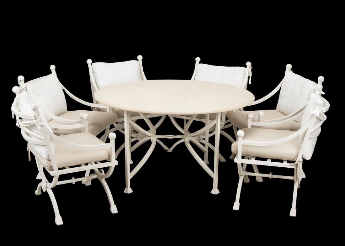 7PC KREISS OUTDOOR DINING SET WITH STONE TOP TABLE: Seven piece Kreiss (American 1939) Mykonos cream finished aluminum outdoor dining set comprising one circular table with faux stone top and six armchairs with cushions, manufacturer's label to the cha