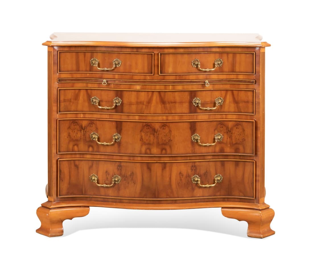 MAITLAND-SMITH GEORGIAN STYLE BURL YEW WOOD CHEST: Maitland-Smith burl yew wood veneer serpentine chest in the Georgian taste, having two short drawers above a slide and three long drawers, and rising on bracket feet, manufacturer's label to the insid