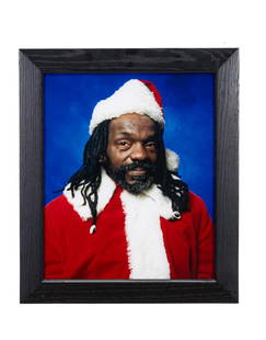 ANDRES SERRANO 'BLACK SANTA' CIBACHROME 10/15: Andres Serrano (American b. 1950), 'Black Santa', cibachrome, 10/15, depicting a black man wearing a Santa Claus costume with a blue background, inscribed and titled en verso, framed. All proceeds fro