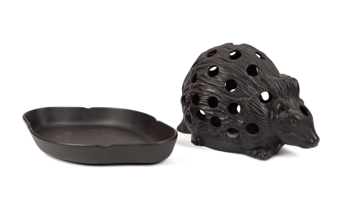 WEDGWOOD HEDGEHOG BULB POT AND STAND: Wedgwood (English 1759), black basalt bulb pot and stand, modeled as a crouching hedgehog, having impressed marks to the underside of each. Provenance: From the Estate of Harriette and Bennett Oxman, 
