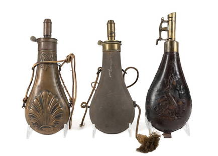 THREE CIVIL WAR ERA POWDER FLASKS & SHOT POUCH: Three Civil War era powder flasks and a shot pouch comprising, a brass 'Shell' and pendant fern flask by the American Flask & Cap Co; a shot pouch in brass and embossed leather having a hunting trophy