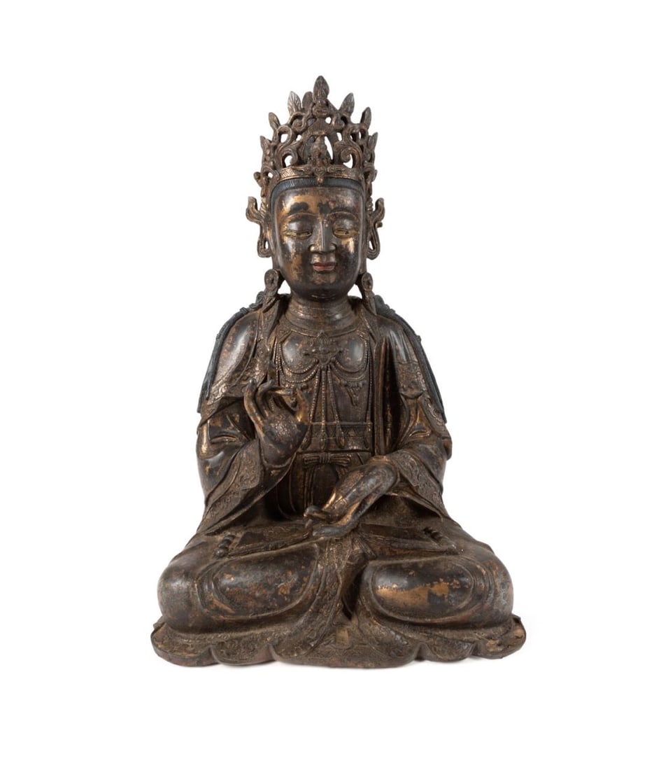 CHINESE GILT BRONZE SEATED QUAN YIN: Chinese gilt bronze Quan Yin, the goddess of mercy seated in the lotus position, the right hand raised in Shuni mudra, the seat of patience, dressed in long robes decorated with flowers at the hems an