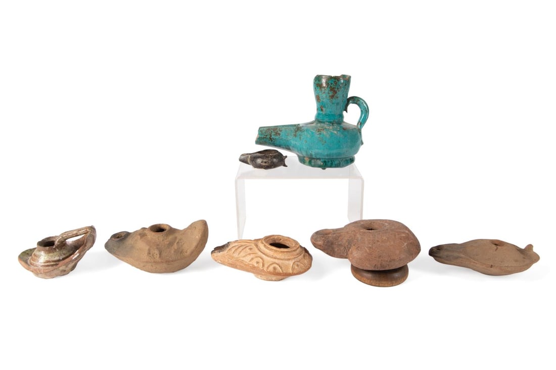 7PCS ROMAN JUDEAN THROUGH ISLAMIC PERIOD OIL LAMPS: Seven molded Roman Judean through Islamic period oil lamps, in terracotta, with and without glazes, comprising one frog lamp with a carinated body, three Judean lamps with vestigial handles, one lamp 