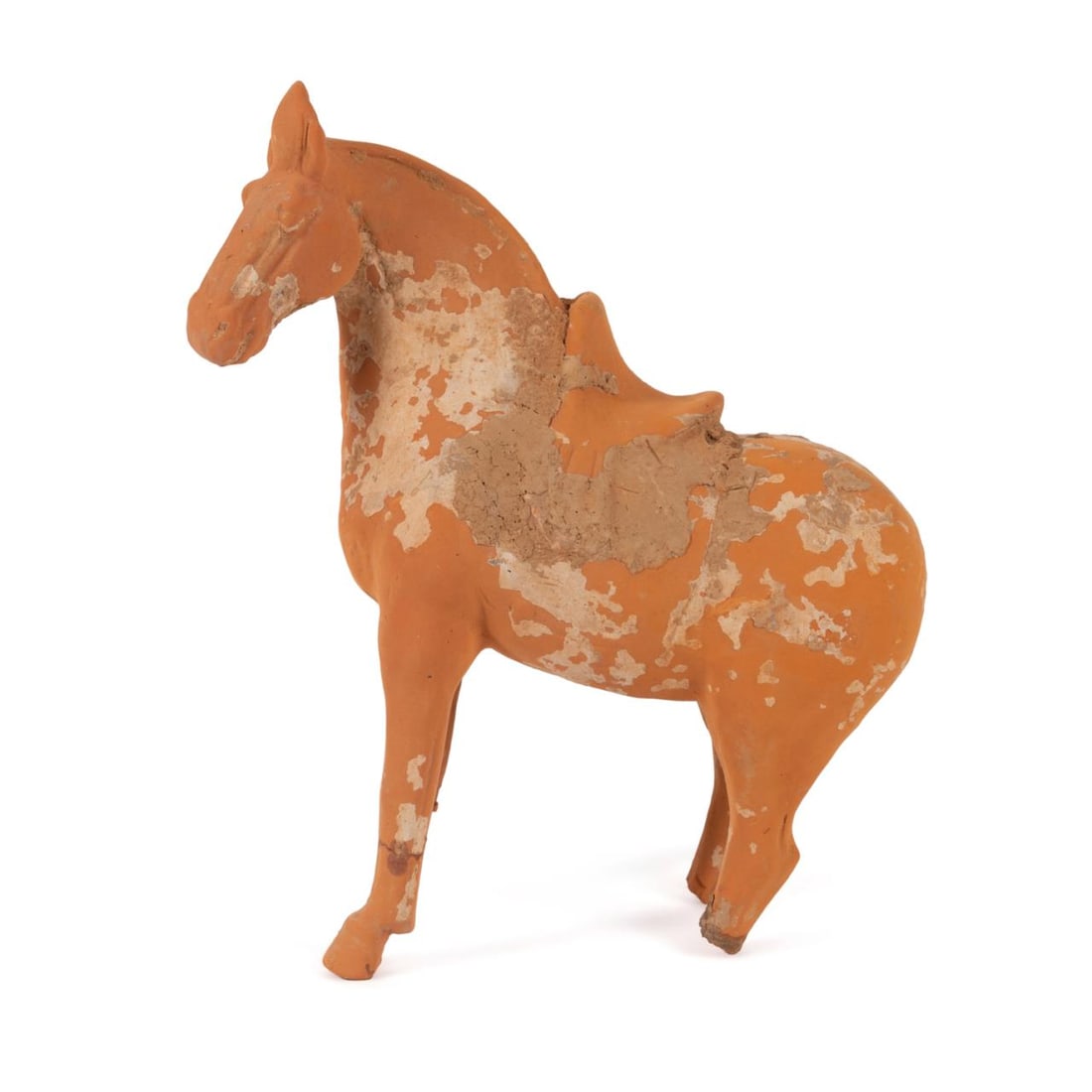 CHINESE TANG DYNASTY TERRACOTTA HORSE: Chinese Tang Dynasty (618 - 907 AD) core formed terracotta horse, modeled standing four-square with head turned slightly to the side and mouth closed, wearing an ornament between the ears and a saddle