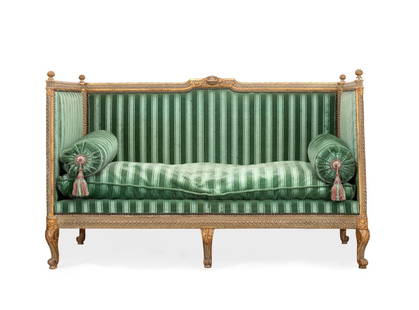 LOUIS XIV STYLE GREEN VELVET ALCOVE SOFA: Manner of Louis Delanois (French 1731-1792), Louis XVI or Transition style carved wood and parcel gilt upholstered alcove sofa, 19th century, with a carved frame having an interlacing motif, striped g