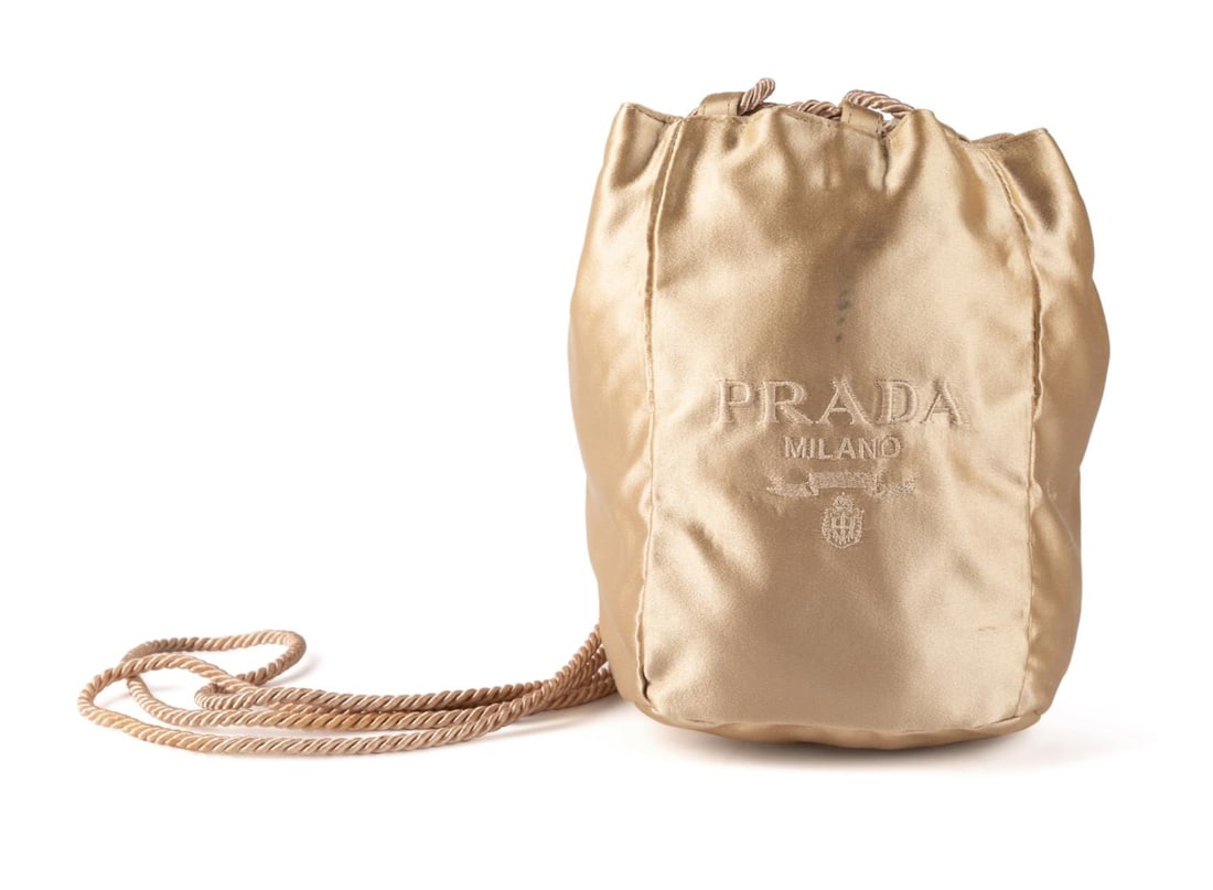 PRADA GOLD SILK POUCH FORM SHOULDER BAG: Prada gold silk drawstring pouch form evening bag with silk cord, with a maker's mark to interior, accompanied by a dust bag. Provenance: From The Estate of Vectra Orkin Barnette, Atlanta, Georgia. Ap