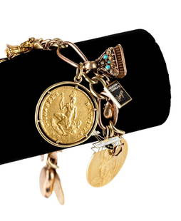YELLOW & ROSE GOLD CHARM BRACELET W/ COINS: Vintage 14k yellow and rose gold link charm bracelet having thirteen (13) charms comprising an 18k yellow gold French Joan of Arc medal, a 14k black, white, and gold enameled biplane, a 14k yellow gol