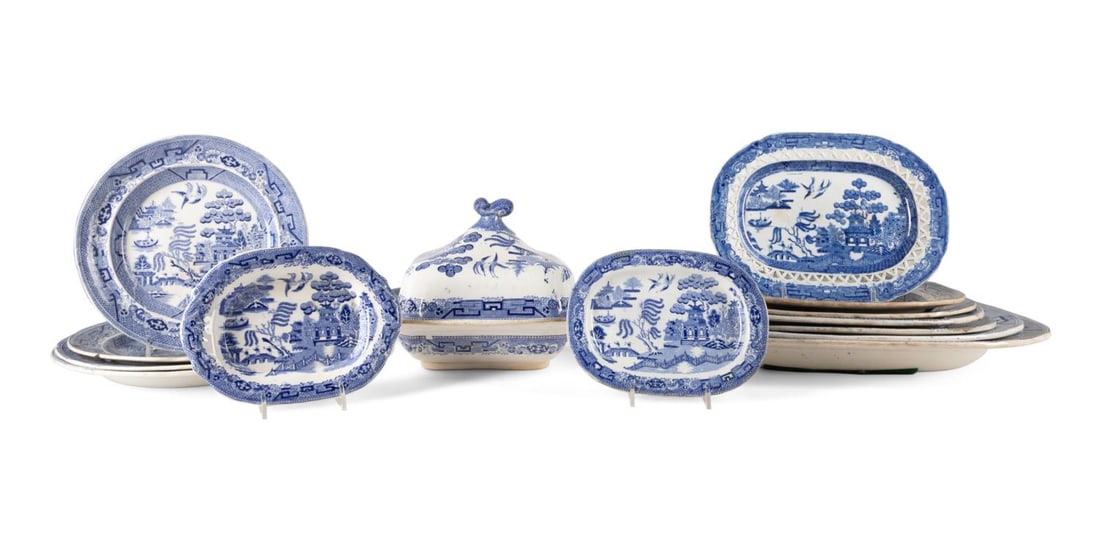 14PCS ENGLISH BLUE WILLOW SERVEWARE, 19TH C.: Fourteen piece collection of English Blue Willow transferware serving pieces, 19th century, comprising, nine platters including one reticulated (largest, h. 14", w. 17.75", d 1.75"), four plates (larg