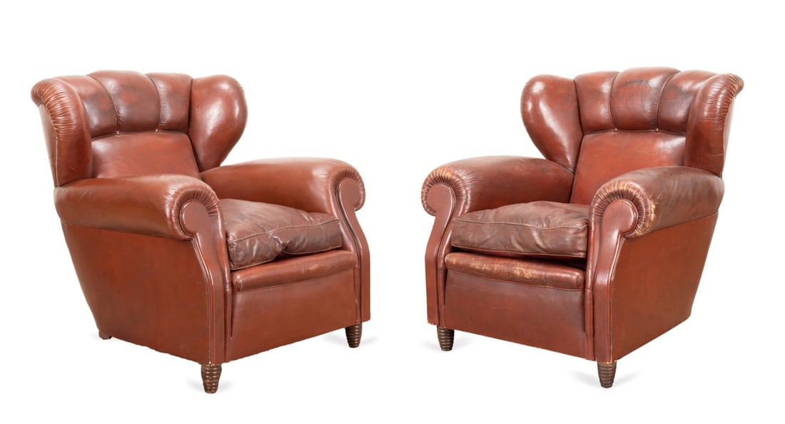 PAIR POLTRONA FRAU LEATHER WINGBACK CHAIRS: Poltrona Frau (Italian 1912), pair of oversized burgundy wingback leather club chairs, having loose down filled seat cushions and rising on tapering turned legs, with manufacturer's plaques to the bac