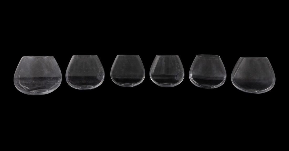 SIX ELSA PERETTI FOR TIFFANY 'THUMBPRINT' GLASSES: Set of six Elsa Peretti (Italian 1940-2021), for Tiffany & Co. (American 1837), ''Thumbprint' pattern (introduced 1978), colorless crystal brandy glasses with acid marks to the underside of each. Prov