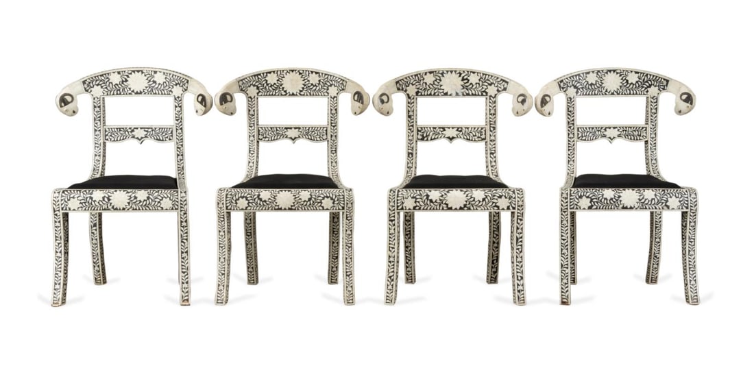 FOUR ANGLO-INDIAN MOGUL STYLE BONE INLAID CHAIRS: Set of four Indian klismos side chairs in the Anglo-Indian Mogul taste, each having foliate bone inlay set in black resin, a ram's head crest rail, and rising on sabre legs, apparently unmarked. Appro