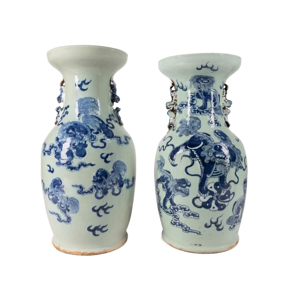 NEAR PAIR CHINESE BLUE & WHITE ON CELADON VASES: Near pair of Chinese blue and white on celadon Fu lion vases, each of baluster form with a dished rim, the trumpet neck flanked by confronting Fu lion handles and the body decorated with frolicking Fu