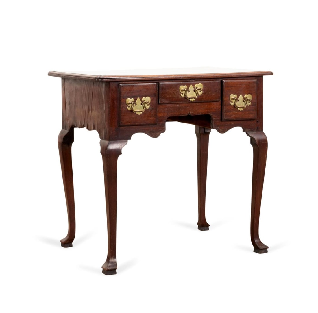 GEORGE III ENGLISH MAHOGANY VENEER LOWBOY: George III English mahogany veneer lowboy, having a rectangular top above a wide shaped apron with three drawers, the whole rising on cabriole legs ending in slipper feet. Approximate dimensions: h. 2