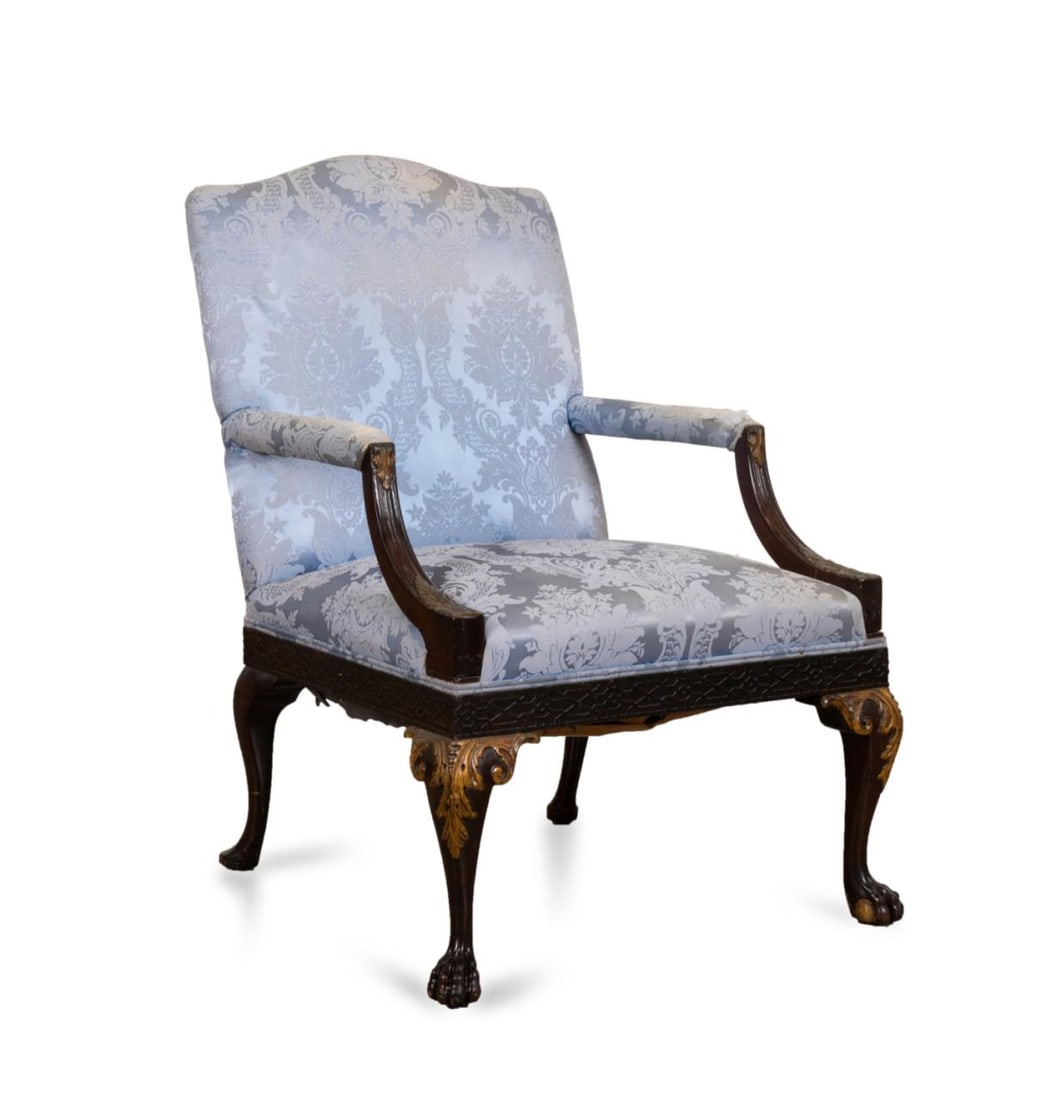 GAINSBOROUGH STYLE ARMCHAIR W/ PARCEL GILT ACCENTS: Ebonized Gainsborough style armchair with parcel gilt accents, having a tablet back and half upholstered arms, upholstered in pale blue silk damask, rising on cabriole legs ending in ball and claw fee