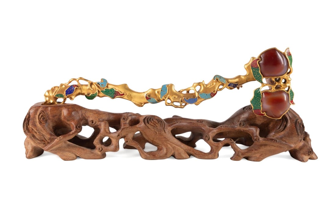 CHINESE GILT BRONZE & ENAMEL SCEPTER ON STAND: Chinese gilt bronze, enamel, and carnelian scepter on stand, having a head set with two carnelian stones carved as peaches, on a gilt bronze twig form body with enamel leaves and tendrils, resting on 