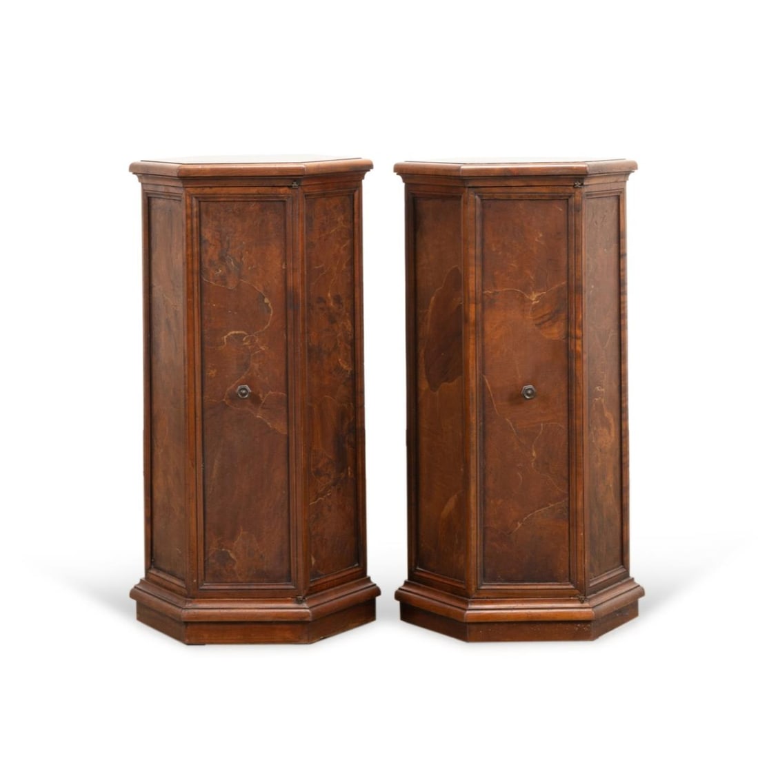 PAIR ITALIAN BURLED VENEER PEDESTAL CABINETS: Pair of Italian burl chestnut veneer hexagonal pedestal cabinets, mid-20th century, each having a single door and rising on plinth base, manufacturer's label to the underside of each. Approximate dime