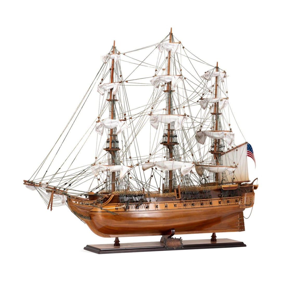 USS CONSTITUTION HAND ASSEMBLED WOODEN SHIP MODEL: American, 20th century. USS Constitution, 3 mast frigate, hand assembled wooden ship model, 'exclusive edition' with crows nests, laser etched serial number on the hull # T0120811006, sitting on a woo