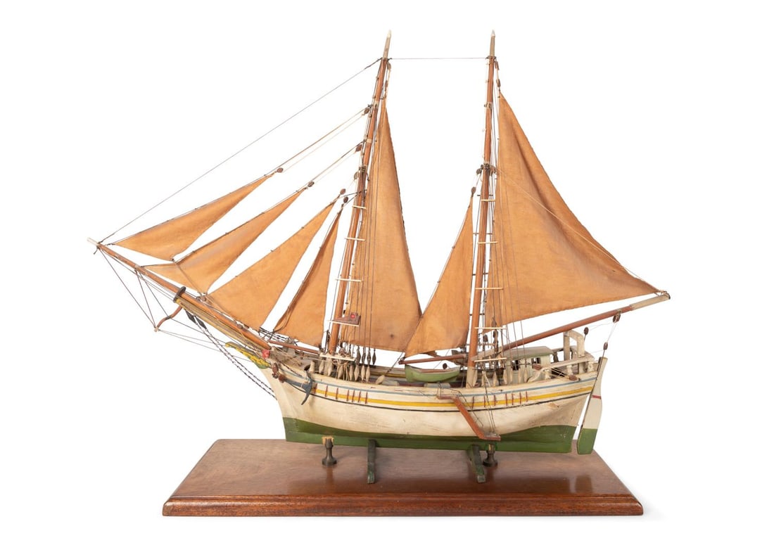 WOODEN MODEL OF A MARKAB OR LEVANTINE SCHOONER: Continental 20th century. Hand made scale wooden model and canvas sails of a Markab or Leventine schooner, a cargo vessel used between Syria, Lebanon, Turkey , Egypt and Isreal mounted on a wooden bas
