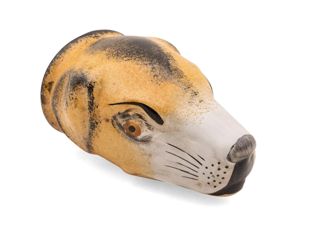 19TH. C. ENGLISH STAFFORDSHIRE TAN DOG STIRRUP CUP: English, 19th century. Staffordshire ceramic stirrup cup of a tan dog, with hand painted features, apparently unmarked. Approximate dimensions: h. 5", w. 3.375", d. 3".