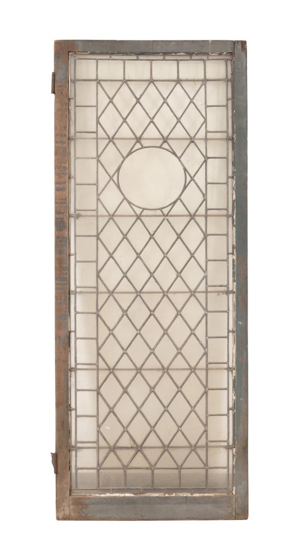 ANTIQUE LEADED TUDOR REVIVAL WINDOW, C. 1925: American or European, circa 1925 or older. Antique colorless geometric pattern leaded glass Tudor or Mediterranean revival window, having a central roundel, set in a wooden frame, apparently unmarked.