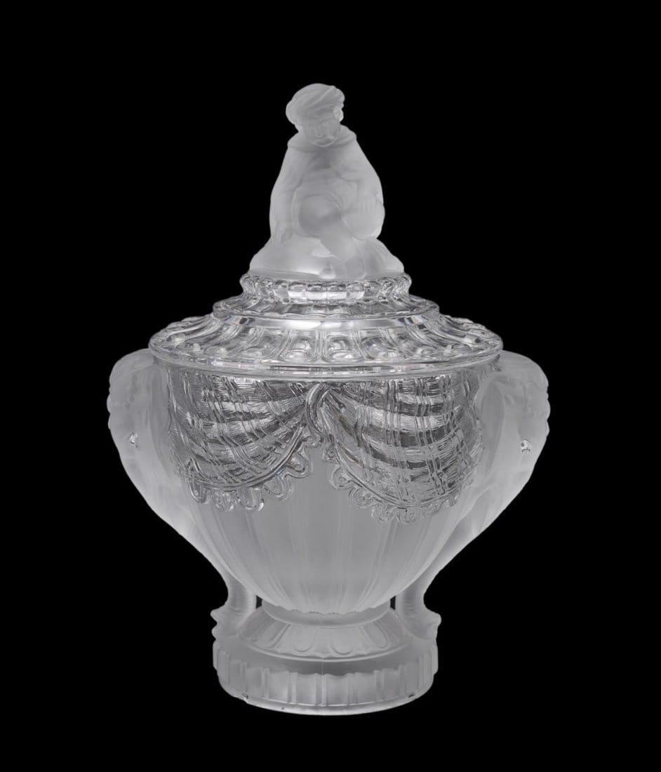 BACCARAT CRYSTAL ORIENTALIST LIDDED BOWL, C. 1890: Baccarat (French, founded 1764), circa 1890. Colorless and partially frosted crystal Orientalist lidded bowl, having a seated child to the lid, the draped body with elephant head handles, molded and a