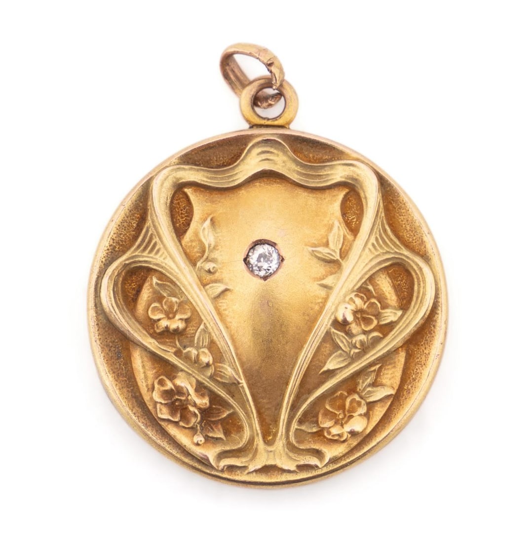 14K PATINATED ART NOUVEAU LOCKET W/ SINGLE DIAMOND: American, 20th century. Art Nouveau locket brooch,14k gold, looks to be rose gold with a yellowish green gold patination, embellished by a single 2mm-.03 carat diamond, monogram engraved on the revers