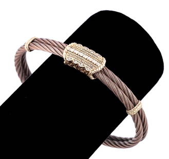 CHARRIOL BRONZE AND 18K GOLD WIRE BRACELET: Charriol Geneve. Signature cable bracelet in 18k gold and bronze, with diamond magnetic clasp. Maker's mark and '750' to underside of clasp. Approximate dimensions: h. 2.25", w. 2.5", d. 0.375", inter