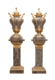 PAIR OF ROCOCO STYLE TESSELLATED URNS ON PEDESTALS
