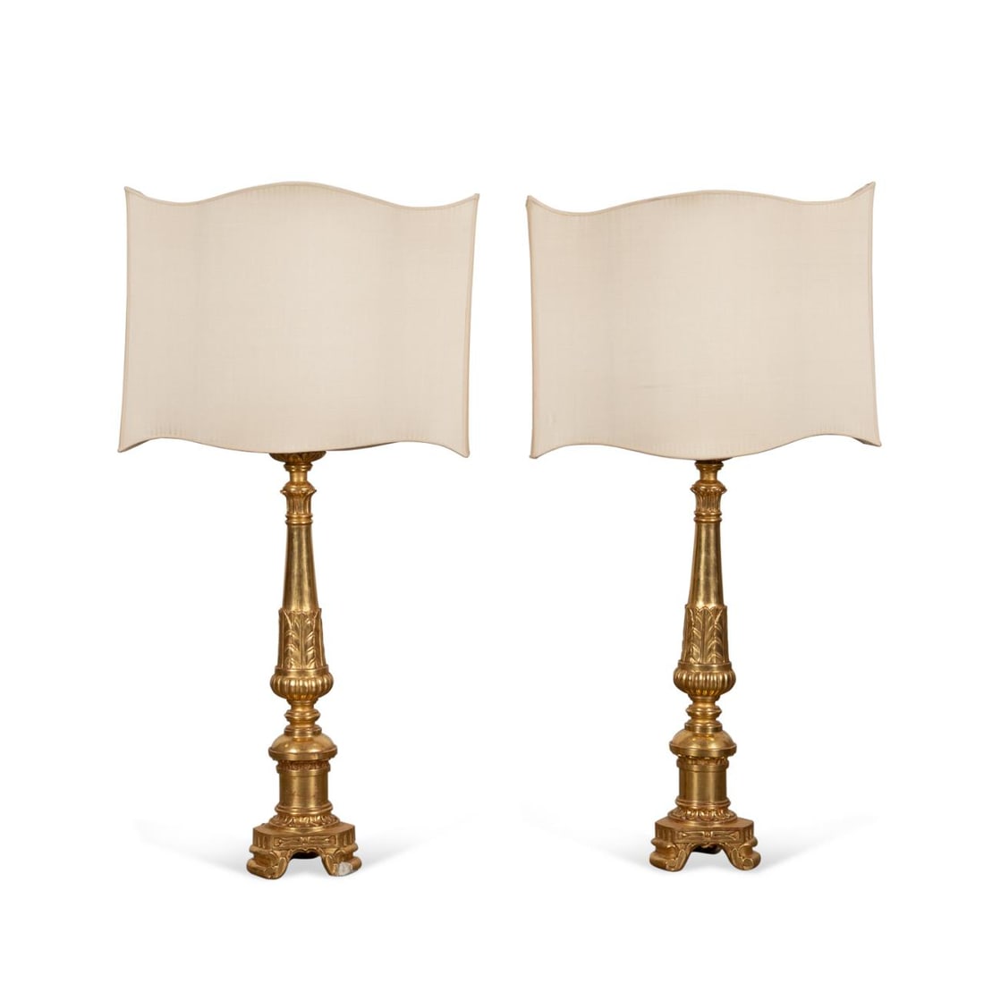 PAIR, PALATIAL BAROQUE GILTWOOD PRICKET LAMPS: Italian. Pair of palatial giltwood lamps in the Baroque taste, each having a spreading shaft with acanthus detail on tripartite base, with custom shade, apparently unmarked. Provenance: Private Collec