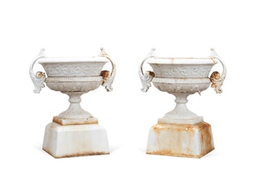 PAIR OF KRAMER BROS. CAST IRON URNS ON PEDESTALS