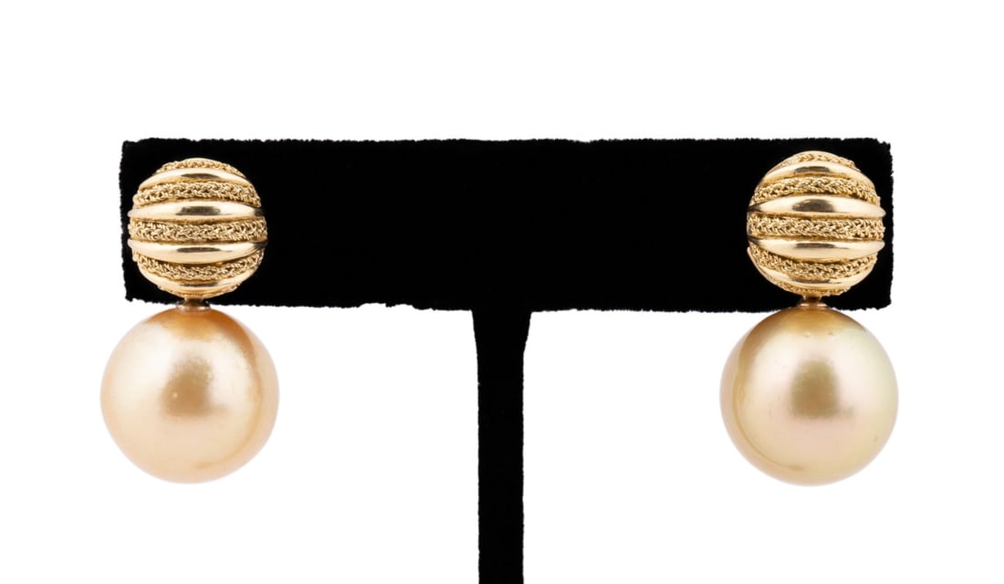 GOLDEN PEARL DROP EARRINGS IN 18K YELLOW GOLD: Pair of 18k yellow gold and yellow pearl drop earrings with (2)15mm pearls, gold studs have a bar at the back for interchangeable drops. Marked "18k" and "Italy" to back of studs. Provenance: Private