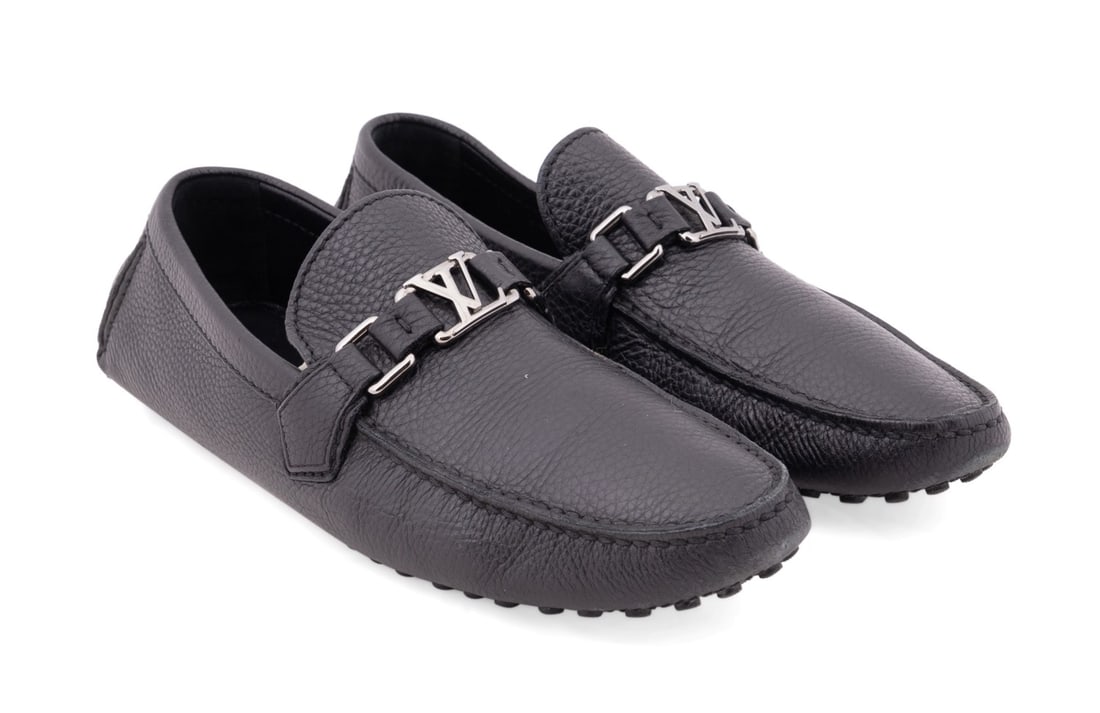 LOUIS VUITTON BLACK HOCKENHEIM DRIVER MOCCASINS: Louis Vuitton. Black leather Hockenheim driver moccasins with silver hardware. Multiple maker's marks, serial number, and "Made in Italy". Accompanied by dust bags, box, and care booklet. Provenance: