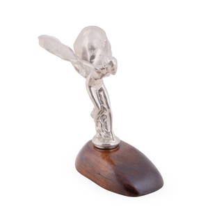 ROLLS-ROYCE 'SPIRIT OF ECSTASY' HOOD ORNAMENT: Rolls Royce (English, founded 1906). Hood ornament, "Flying Lady" known as the "Spirit of Ecstasy', after Charles Robinson Sykes (1875-1950), cast base metal mounted on a mahogany base and marked "Reg