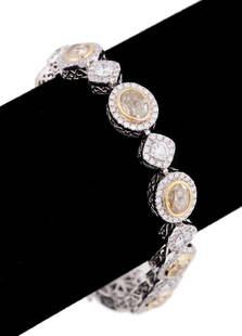 UNEEK 11.2 CTW DIAMOND LINK 18K WG BRACELET: Uneek by Benjamin Javaheri. Yellow diamond and diamond link bracelet in 18k white gold, with (8) oval brilliant cut diamonds weighing approximately 7.70 total carats (VS-2 clarity and Fancy Light Yell