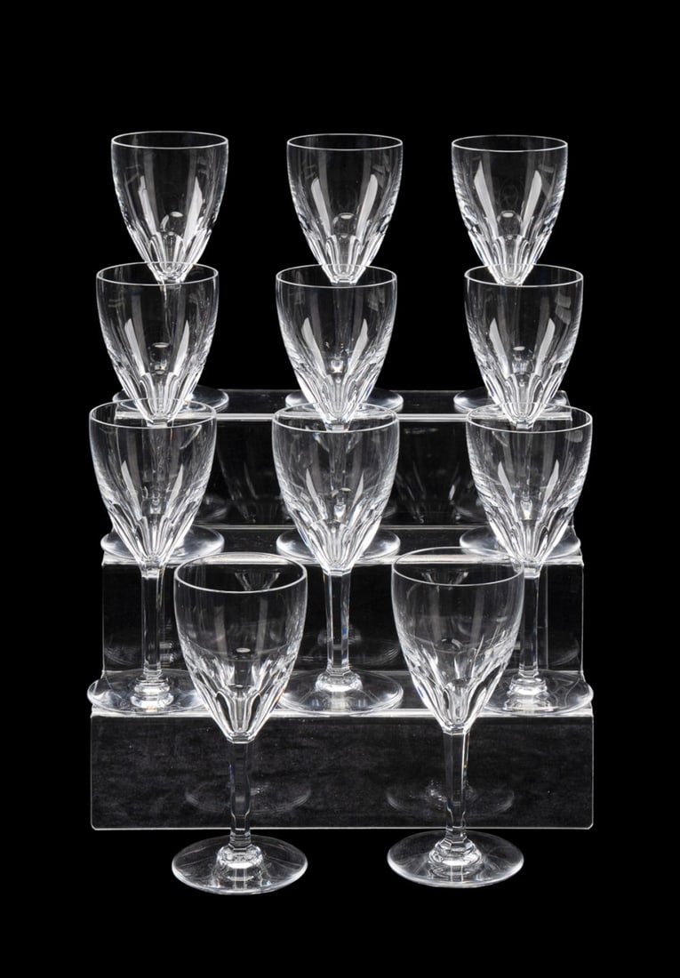 BACCARAT, SET OF 11 'GENOVA' WATER GOBLETS: Baccarat (French, founded 1764). Set of 11 "Genova" (pattern introduced 1981) colorless crystal water goblets, each rising on a round foot, all marked appropriately to underside. Provenance: Private C