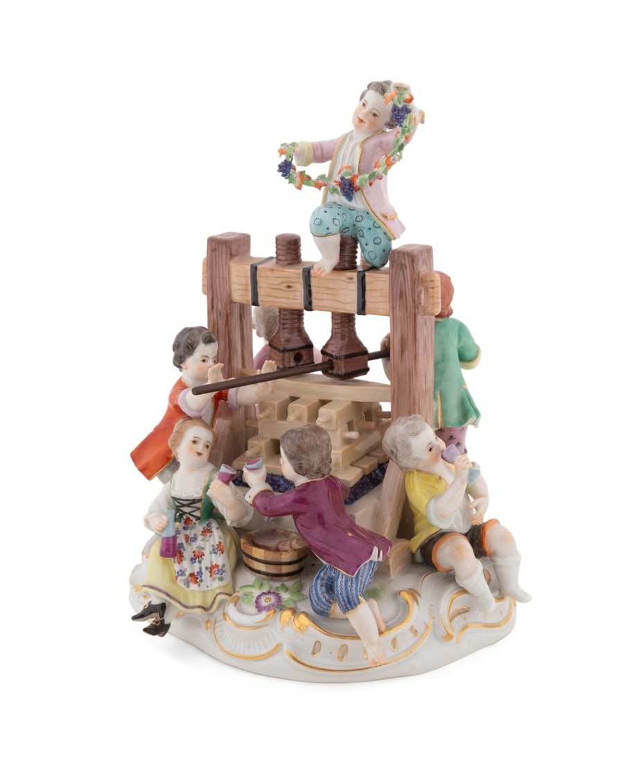 MEISSEN 'THE WINE PRESS' PORCELAIN FIGURINE: Meissen (German, founded 1705), 20th century. "The Wine Press", children drinking and making wine on a molded rocaille base, appropriately marked. Approximate dimensions: h. 10", w. 8", d. 7.625".