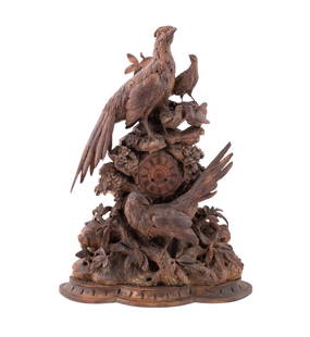 LARGE BLACK FOREST CARVED FLORA AND FAUNA CLOCK: Swiss or German, 19th century. An elaborately carved, large Black Forest clock featuring a woodland theme with five birds perched on rocks and a tree limb, surrounded by flora, clock face has applied