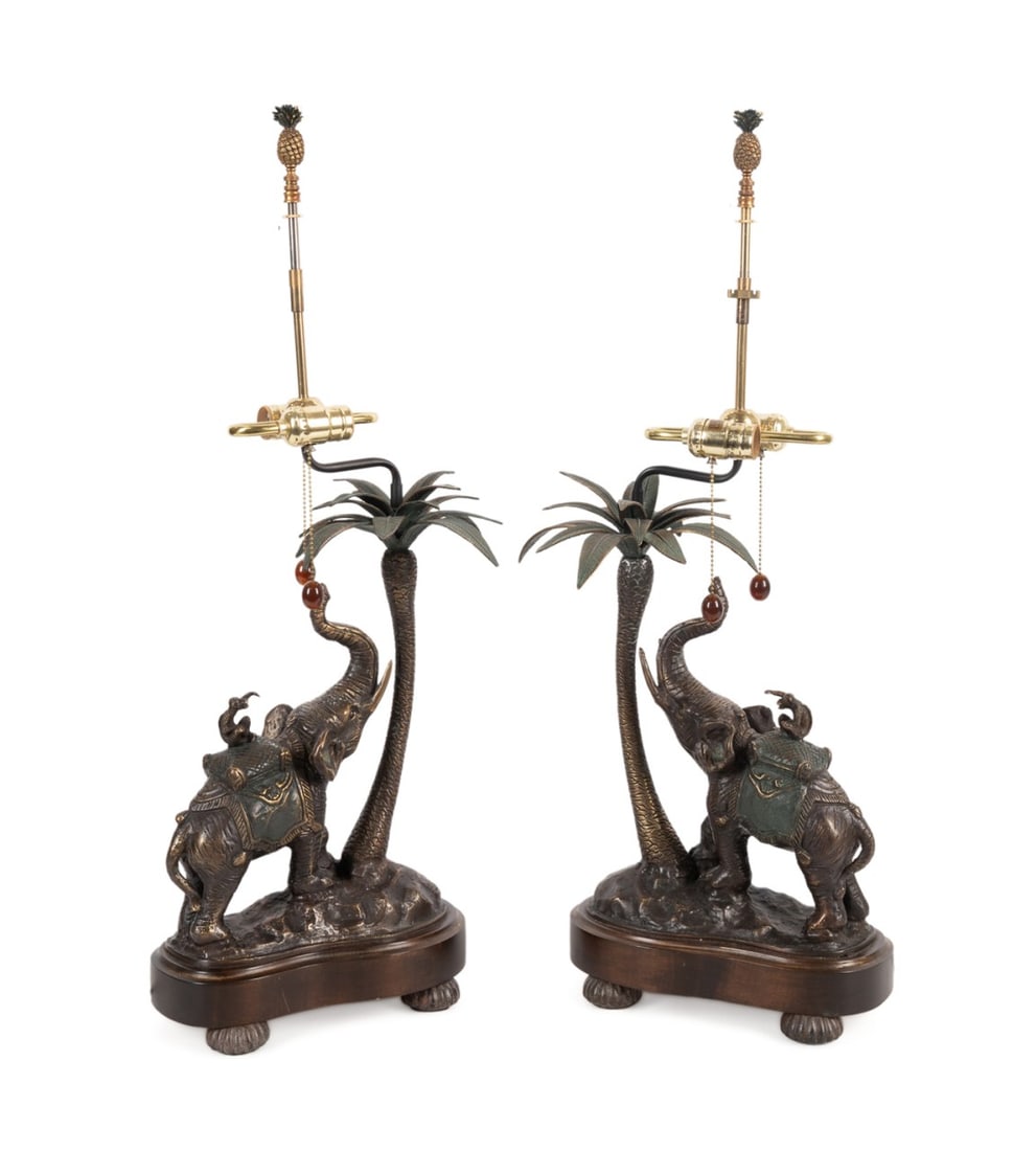 FREDERICK COOPER, PAIR OF TROPICAL MOTIF LAMPS: Frederick Cooper Lamp Co. (American, founded 1923), late 20th century. Pair of patinated bronze tropical motif 2-light lamps, each modeled as an elephant with monkey under a palm tree, both appropriat