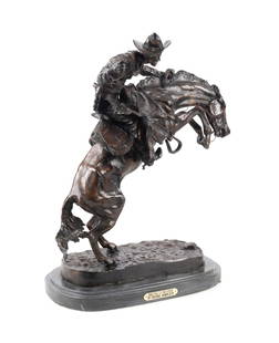 'BRONCO BUSTER' BRONZE SCULPTURE, AFTER REMINGTON: After Frederic Remington (American, 1861-1909). "Bronco Buster" - 20th century, cast patinated bronze on marble base, incised signature, title, and dated to bronze base. Approximate dimensions: overal