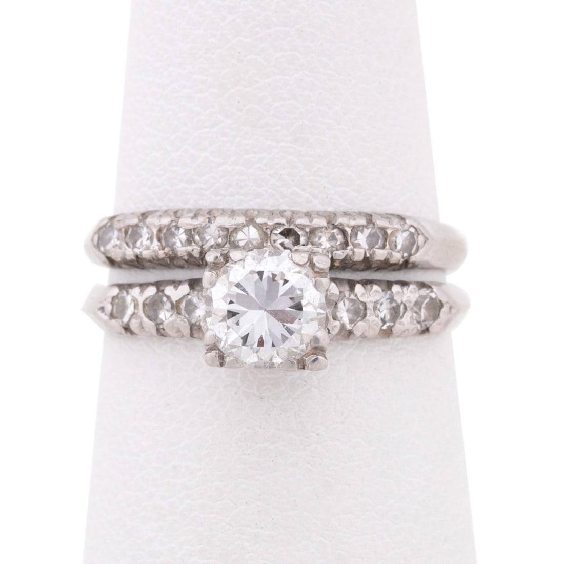 DIAMOND PLATINUM WEDDING SET: Diamond wedding set including one engagement ring and one wedding ring, engagement ring features a round brilliant transitional cut diamond weighing approximately 0.60 total carats of VS-2 clarity and