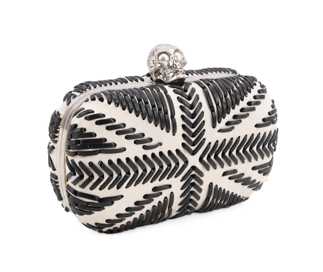ALEXANDER MCQUEEN WHIPSTITCH BRITANNIA SKULL CLUTCH: Alexander McQueen (British, founded 1992). Whipstitched calfskin leather Britannia skull box clutch with silver toned frame and hardware, jewel embellished skull closure, and black leather interior. A