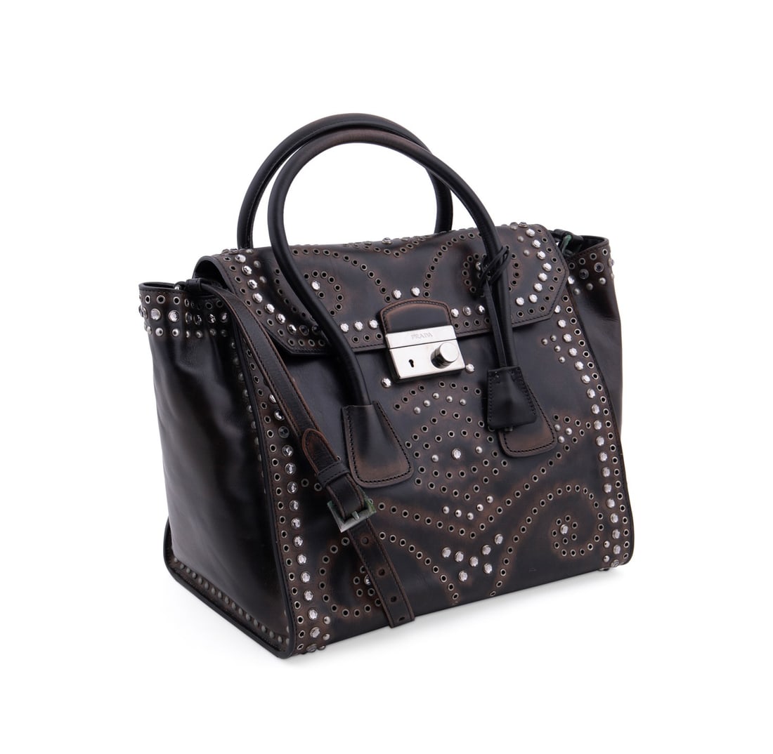 PRADA 'VITELLO VINTAGE' LEATHER EMBELLISHED BAG: Prada (Italian, founded 1913). Embellished "Vitello Vintage" leather "Sound Twin" top handle bag with silver tone hardware. Accompanied by removable cross-body strap, leather key bell, extra key, auth