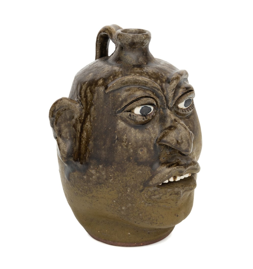 LANIER MEADERS, GEORGIA FOLK POTTERY FACE JUG: Lanier Meaders (American (Georgia), 1917-1998). Stoneware face jug, in a brown glaze, having stone teeth, signed to underside. Note: Meaders pieces are in the permanent collection of the Smithsonian A