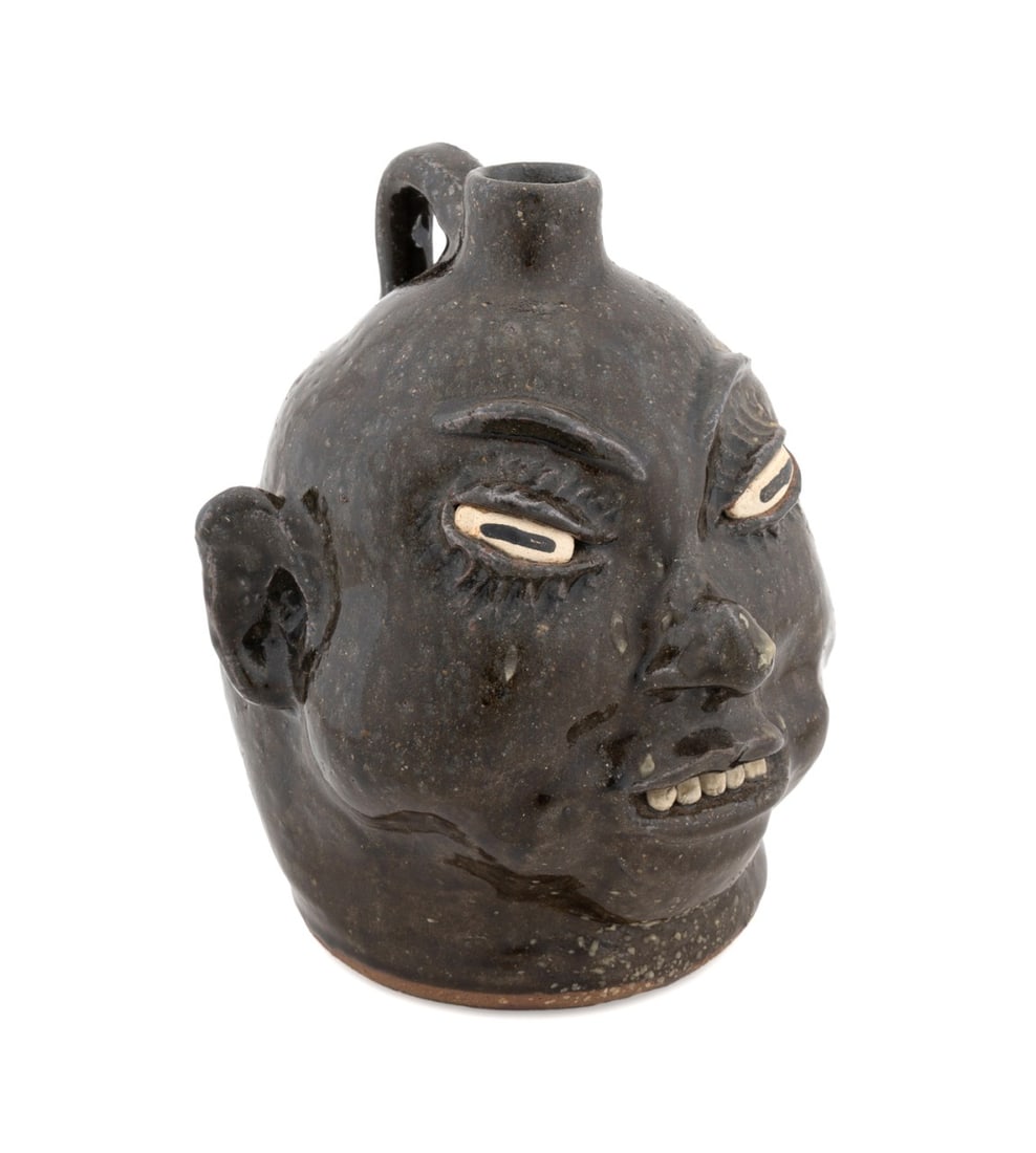 LANIER MEADERS, GEORGIA FOLK POTTERY FACE JUG: Lanier Meaders (American (Georgia), 1917-1998). Stoneware face jug, in deep green/brown glaze, having five stone teeth, signed to underside. Note: Meaders pieces are in the permanent collection of the
