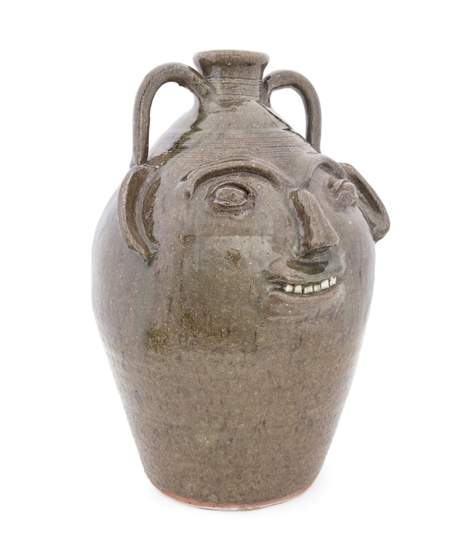 BURLON CRAIG, 17.5" SOUTHERN POTTERY FACE JUG: Burlon Craig (American (North Carolina), 1914-2002). Face jug in olive glazed stoneware with porcleian teeth, signed to back under neck. Note: Craig's pieces are in the permanent collection of the Smi